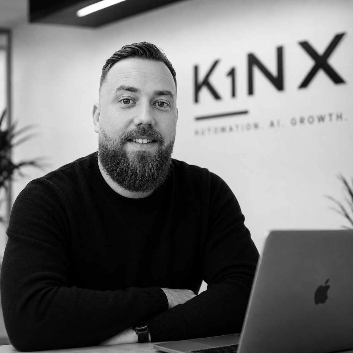Kevin Ensmann, Gründer von K1NX, an seinem Schreibtisch vor dem K1NX-Logo